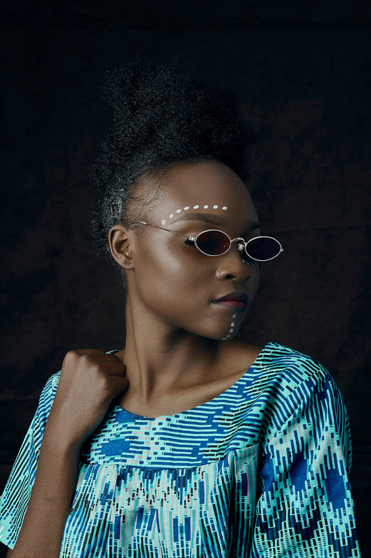 woman in blue and white striped shirt wearing sunglasses