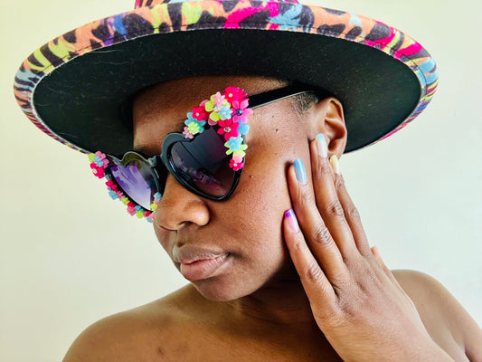 A woman wearing a colorful hat and sunglasses